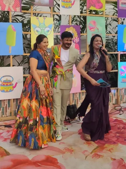 Taking on the role of a red carpet host to interview guests at a pre-wedding carnival. It's a fun way to create a surprise video for the couple with wishes and memories from their loved ones.
