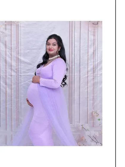 A classic full-length solo portrait. The simple pose and clean background allow the beauty of the mom-to-be and her lavender gown to be the complete focus of the image.