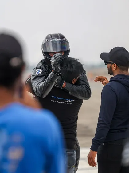A moment of sportsmanship and camaraderie between two racers after a run. The Vroom community is built on mutual respect and a shared passion for motorsport.