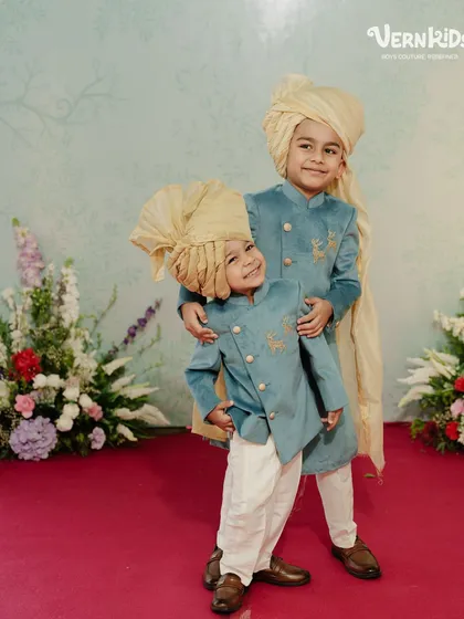 Double the charm, double the style. These brothers look absolutely adorable in their matching blue velvet sherwanis and traditional turbans, ready for a family wedding.