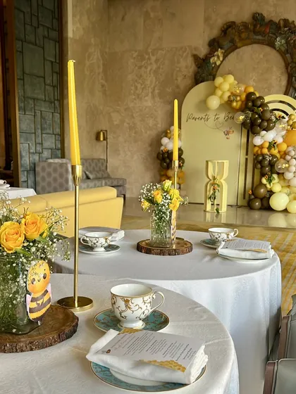 Elegant table settings for the 'Mommy to Bee' themed baby shower. We used fine china, yellow taper candles, and fresh yellow roses to create a sophisticated high-tea experience.