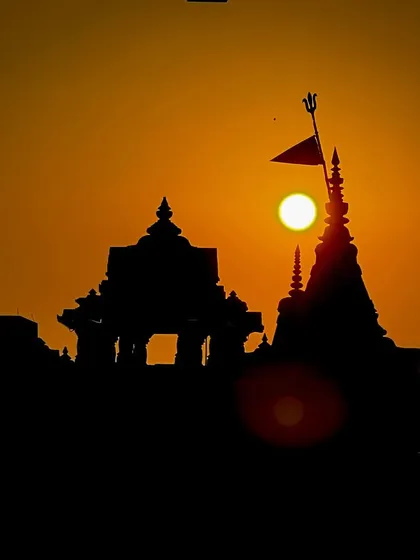 A temple stands in silhouette against the morning sun. For me, this is a moment of quiet devotion, where faith and nature meet in a simple, powerful frame. This is a classic golden hour shot that speaks to India's spiritual heart.