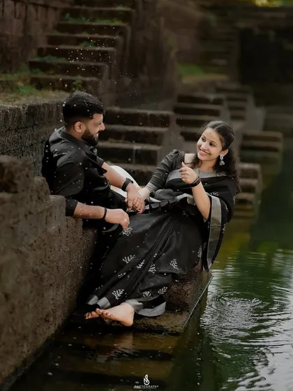 A playful moment splashing water in the temple pond. This adds a fun and spontaneous element to the traditional photoshoot.