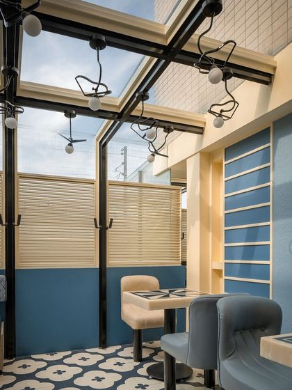 The custom light fixtures in the blue zone of Masala were designed to be both functional and sculptural. Their playful, bird-like forms add a dynamic element to the space, especially when viewed against the sky through the glass roof.