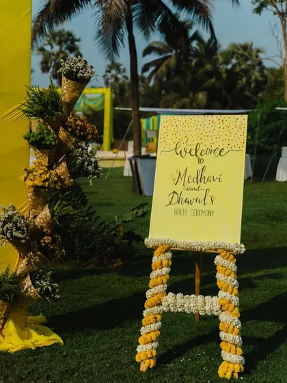 A personalized welcome sign is a great way to greet your guests. Here, I decorated the easel with marigold garlands to match the Haldi theme.