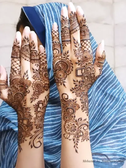 An intricate Arabic henna design with beautiful swirls, florals, and geometric elements.