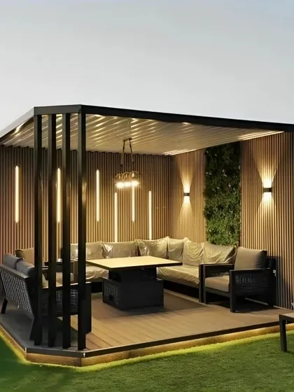 For this terrace, the goal was to create a sophisticated evening entertainment lounge. The design features a modern black pergola with slatted wood walls, a large L-shaped sofa, and a central dining table. I integrated multiple lighting solutions, including vertical LED strips, wall sconces, and under-deck lighting, to set the perfect mood after dark.