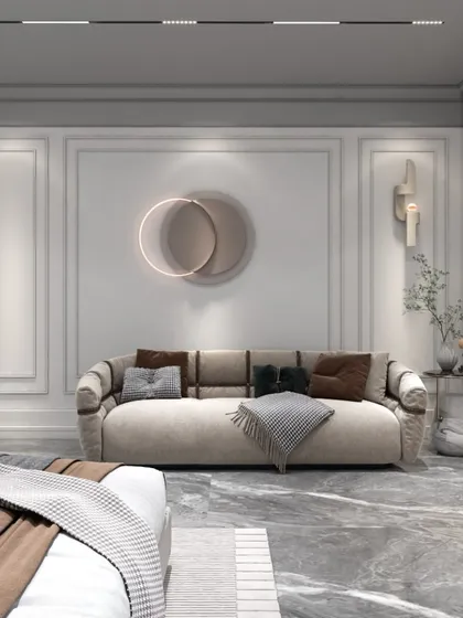 This view showcases the cozy seating area within the bedroom, featuring a plush sofa and modern wall art. The space is designed to be a peaceful corner for reading or relaxing.