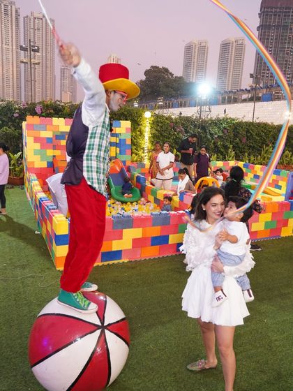 A stilt-walker entertains guests, adding to the lively and interactive atmosphere of our outdoor circus-themed party.