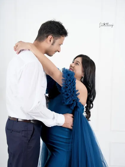 A dreamy and romantic dance pose between a couple. The flowing blue gown and their intimate embrace create a beautiful and dynamic portrait.