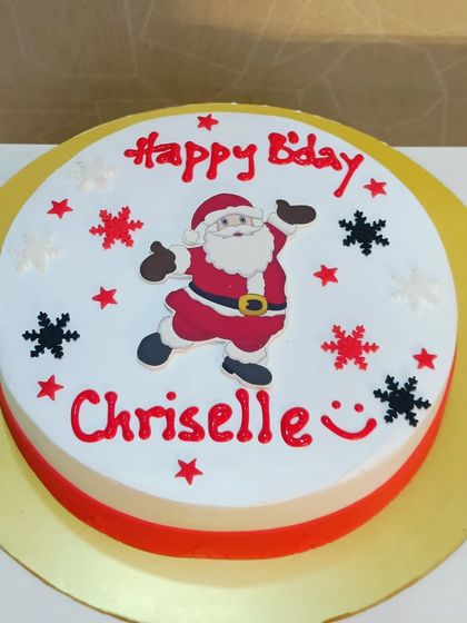 A cheerful Santa-themed cake for a Christmas birthday. The simple, clean design is fun and festive.