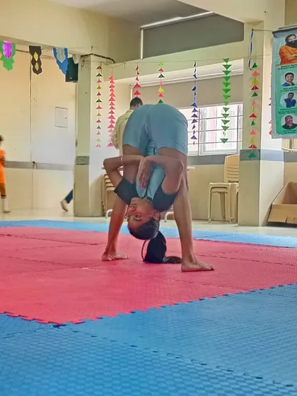 Deepa demonstrating her winning form with an incredible forward bend during the competition.