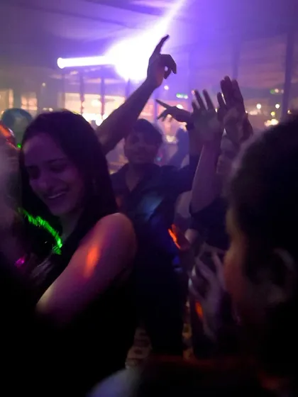 Another shot of the crowd lost in the moment, dancing with their hands in the air.