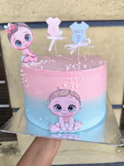 If you're not a fan of fondant but still want cute characters on your cake, edible prints are the perfect solution. This baby shower cake uses colorful cutouts on a beautiful pink and blue ombre buttercream base.