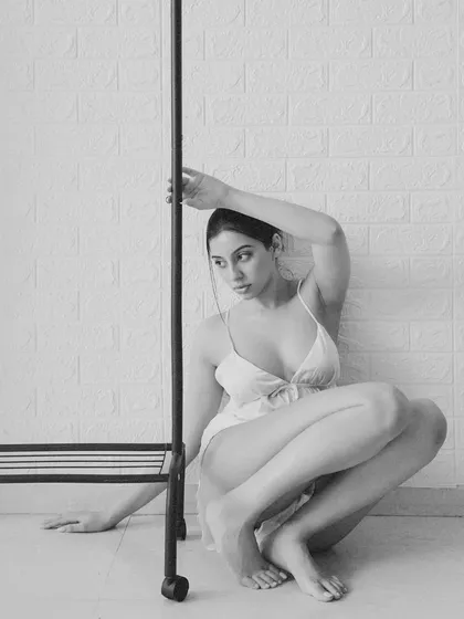 The same setup, but in black and white. Stripping away the color emphasizes the lines, shadows, and the model's form, giving the image a more classic and timeless feel.