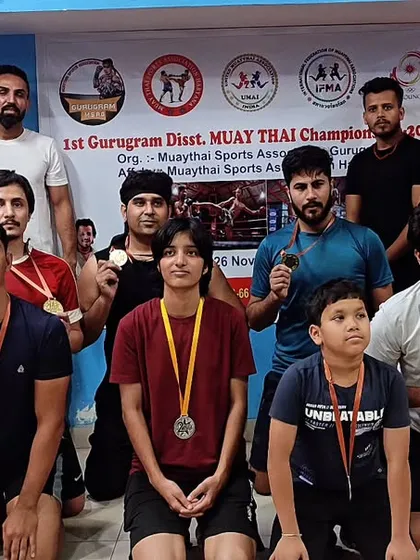 Our Muay Thai warriors after conquering the district tournament. This picture captures the grit and success of our team as they prepare to take on the state level competition.