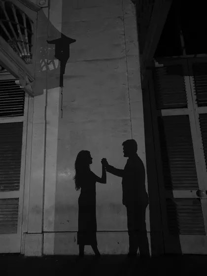 A creative use of shadow play, creating a silhouette of the couple dancing. This is storytelling through light and its absence.