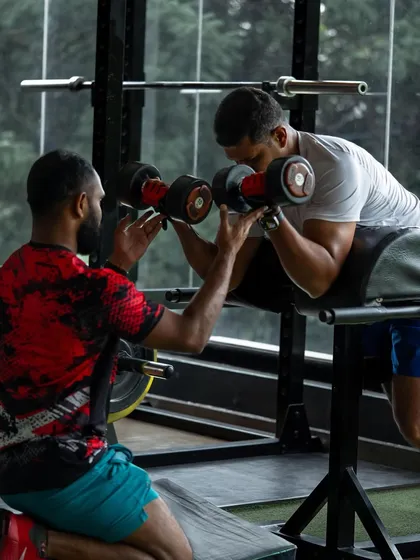 Perfecting your form is key to getting stronger and avoiding injury. I provide hands-on spotting and guidance for every exercise, like this dumbbell curl, to ensure you get the most out of every rep safely.