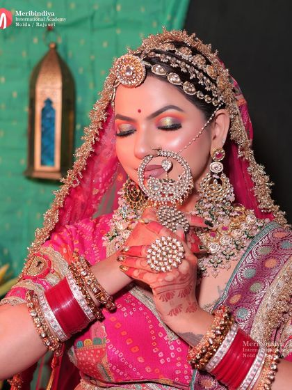 This pose showcases the detailed eye makeup and the traditional jewelry that are integral to this look.