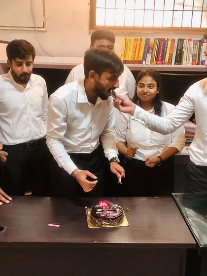 Celebrating the birthdays of two team members in the office. These moments of celebration are vital for team bonding and maintaining a positive work atmosphere.