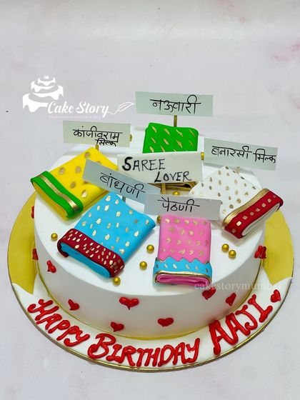 A cake for a true saree lover! This design is for an 'Aaji' (grandmother) and features different types of miniature fondant sarees like Paithani, Bandhani, and Kanjivaram.