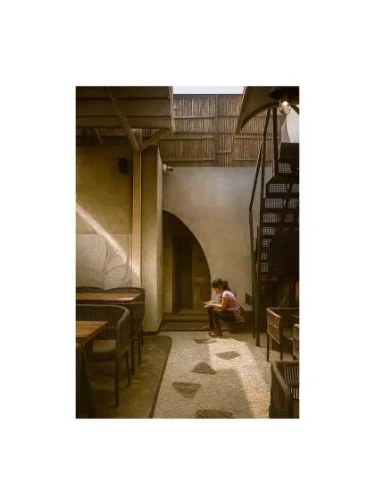 I love creating quiet nooks where people can read or reflect. This corner of the Jalandhar cafe uses an arched doorway and pebble flooring to create a distinct, peaceful zone within the larger space.