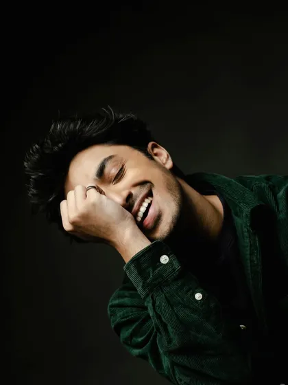 A candid moment from a men's styling portfolio shoot with Lakshya Parikh. Even in a simple green corduroy shirt, the right fit and a genuine smile can create a powerful and relatable image. It shows that great style is also about comfort and personality.