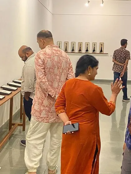 A visitor at the opening of 'Quieter than Silence', smiling for the camera.