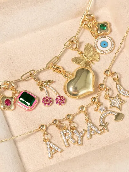Customize your favorite necklace. This image shows a variety of charm options, including initial letters, butterflies, and gemstones, that you can add to my link chain necklaces.
