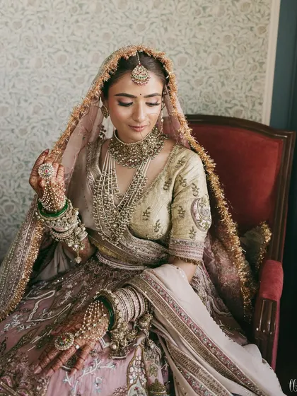 Crafting a look that feels like a modern heirloom is my passion. This bride's pastel lehenga with intricate detailing and layered jewelry created a portrait of timeless elegance and regality.