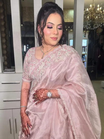 A gorgeous party look. The soft pink organza saree is complemented by a matching pink-toned makeup look and a chic high ponytail.