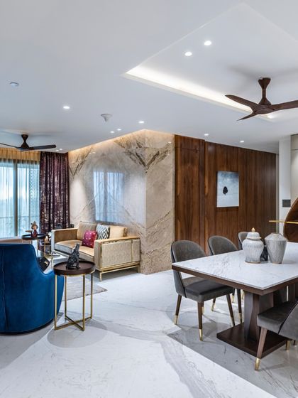 This open-plan living and dining area from the Filigree House project showcases modern elegance. I selected sleek sofas and a refined dining table, using minimalist hues and subtle wooden accents to create a tranquil, cohesive environment.
