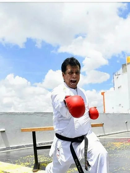 The spirit of karate is captured in this moment of intense focus and power. Hanshi Sir demonstrates a gyaku zuki, or reverse punch, with a powerful kiai.