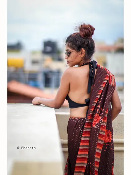 A back-profile shot from the rooftop series, overlooking the city. This image emphasizes the halter-neck design and the urban setting.