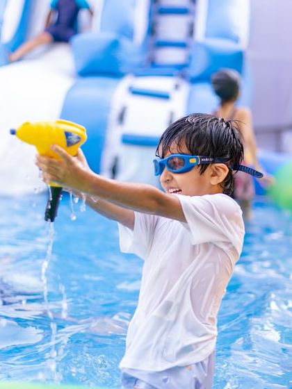 A water gun fight in full swing! Simple toys like water guns can provide endless fun and are a must-have for any pool party.