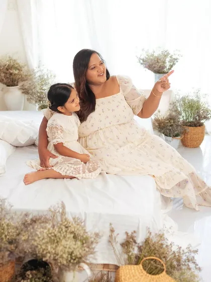"Look over there!" A mother points something out to her daughter in this sweet, candid moment from their studio family session.
