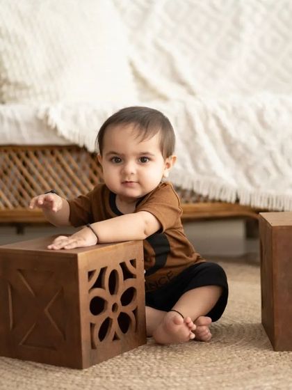 A sweet moment of a baby playing with blocks in our natural-themed studio.