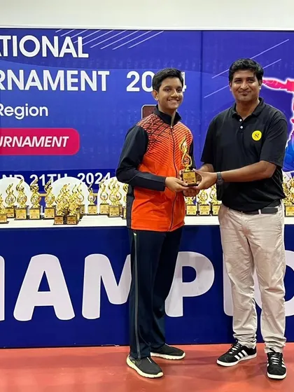 Celebrating the success of a young athlete as he receives his trophy at the national tournament.