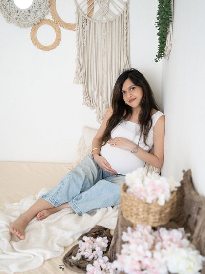 A relaxed and happy portrait in our minimalist studio setup. The natural textures and soft light create a warm and inviting atmosphere.