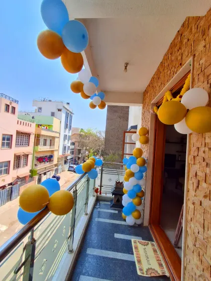 Welcoming a new baby starts at the front door. Here, I decorated the balcony with a simple garland of blue, yellow, and white balloons.