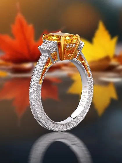 Autumn Radiance. This exclusive Topaz gemstone ring, with its intricate, engraved two-tone band, is crafted to reflect the season’s warm hues. Perfect for those who cherish personalized elegance.