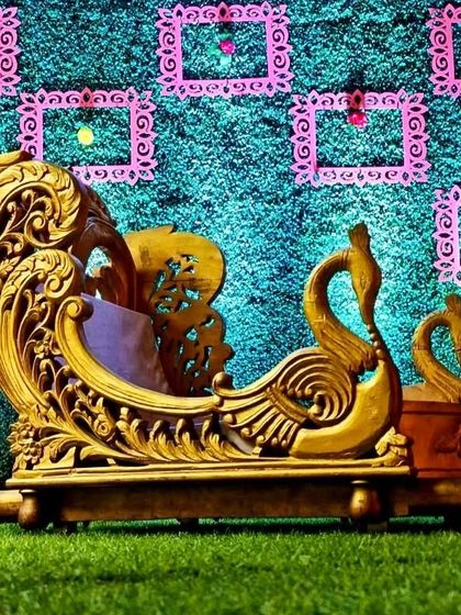 This is our carved golden doli with a swan motif. It has a very royal and intricate design, perfect for a bride who wants a grand and artistic palki for her entry.