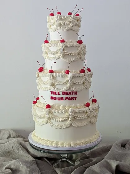 I've always wanted to make a grand, multi-tiered vintage cake. This design, with its intricate buttercream piping and cheeky "Till Death Do Us Part" message, brings a bit of old-school romance and fun to a wedding celebration.