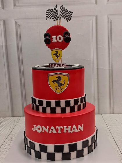For the young racing enthusiast, we created this two-tiered Ferrari cake. The bold red fondant, checkered flag details, and iconic Ferrari shield make it a winning centerpiece for a 10th birthday.