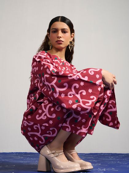 Another look from the Joskai Studio campaign, this time a maroon printed co-ord set. The squatting pose is modern and confident, showcasing the outfit in a non-traditional way.