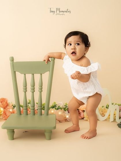 Standing tall. Capturing the wobbly first steps and standing poses is a highlight of any one-year milestone session.