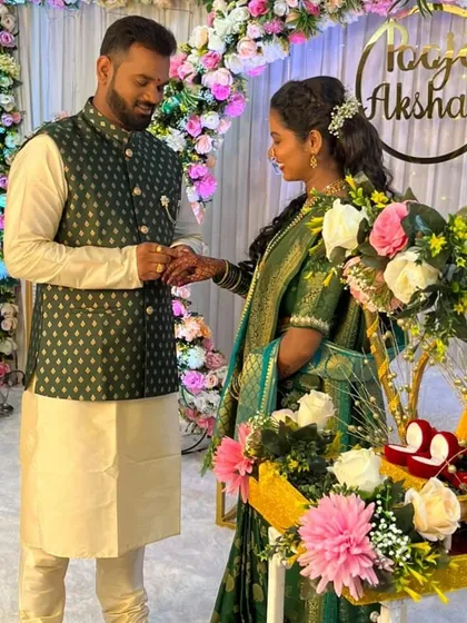 The ring exchange moment, captured in front of our floral arch. We also provided the decorated ring platter seen here to match the overall engagement theme.