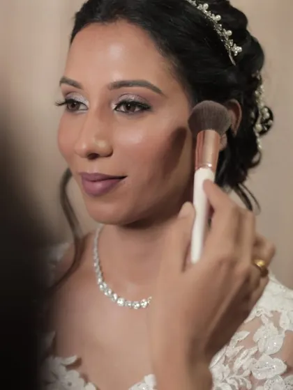 A close-up of the makeup application process. We use soft brushes and luxury products to create a flawless, custom-matched foundation base for a seamless finish.