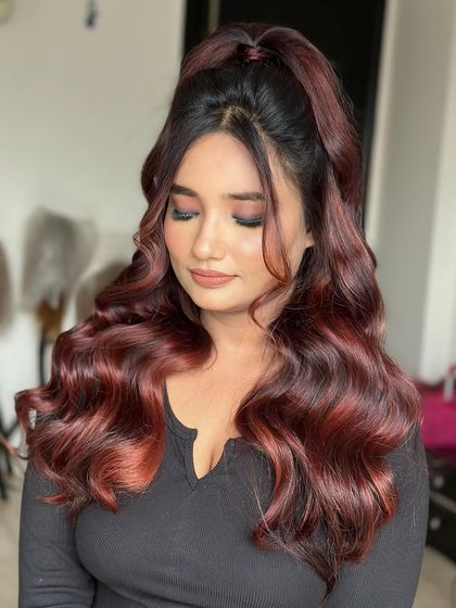 Slaying in her top knot waves with a gorgeous burgundy hair color. This half-up style is modern, chic, and very trendy.