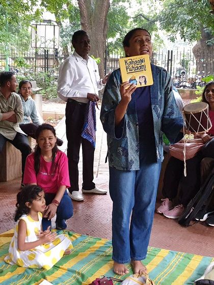 Using a small drum, or 'djembe', to add a rhythmic element to the story. Music and sound are key tools I use to make our readings more immersive and engaging for young children.